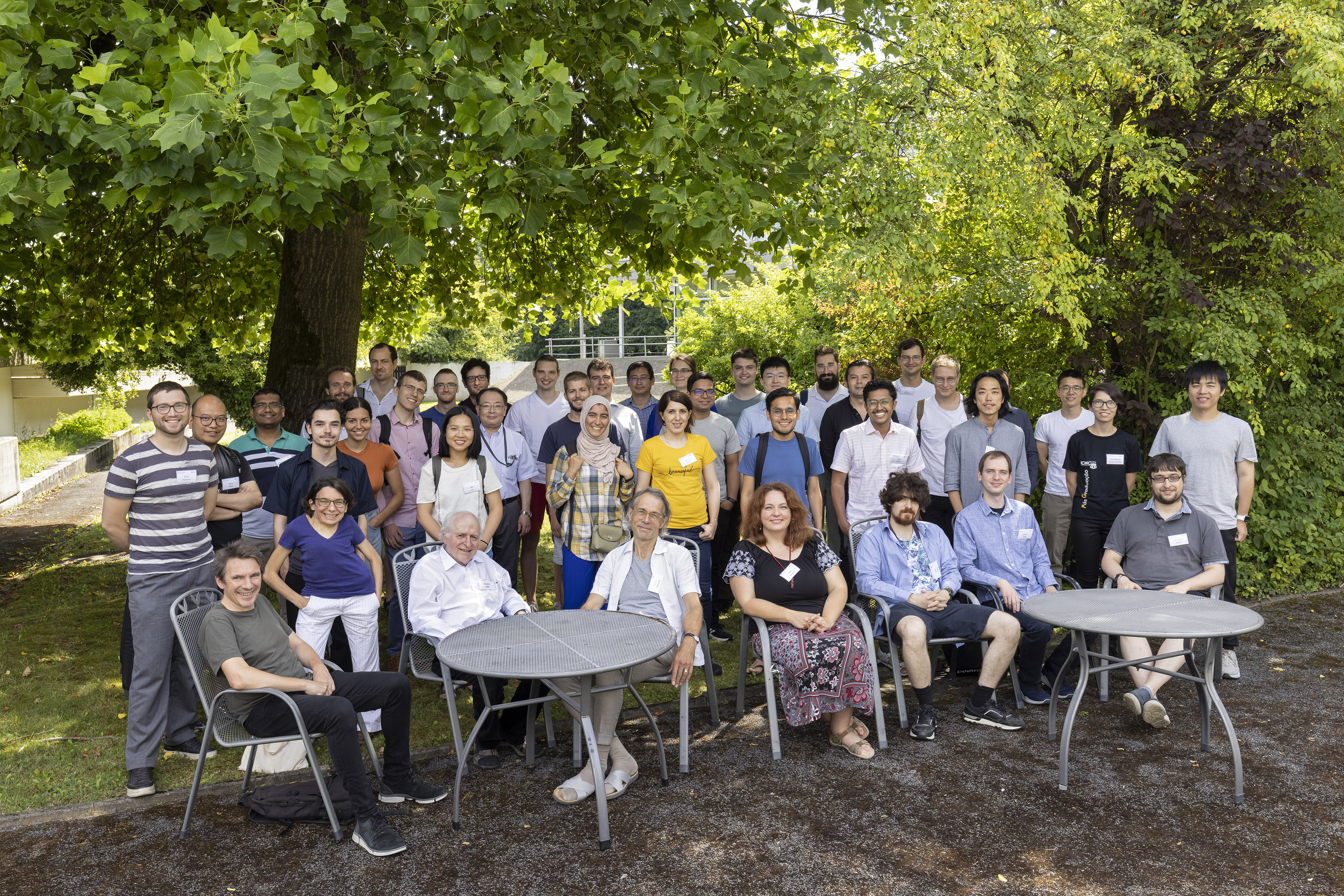 Group picture from a Summer School outside in ZiF's garden in front of trees