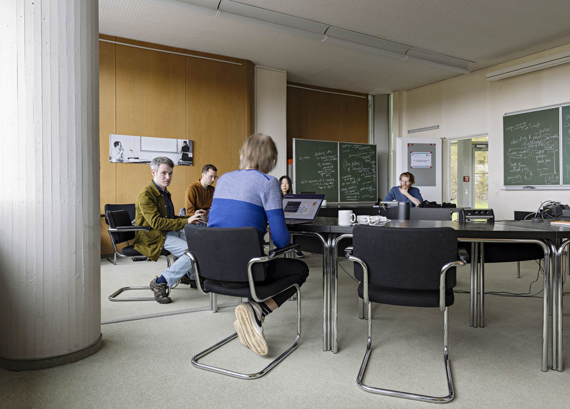 People discussing something in the Round Table Room.