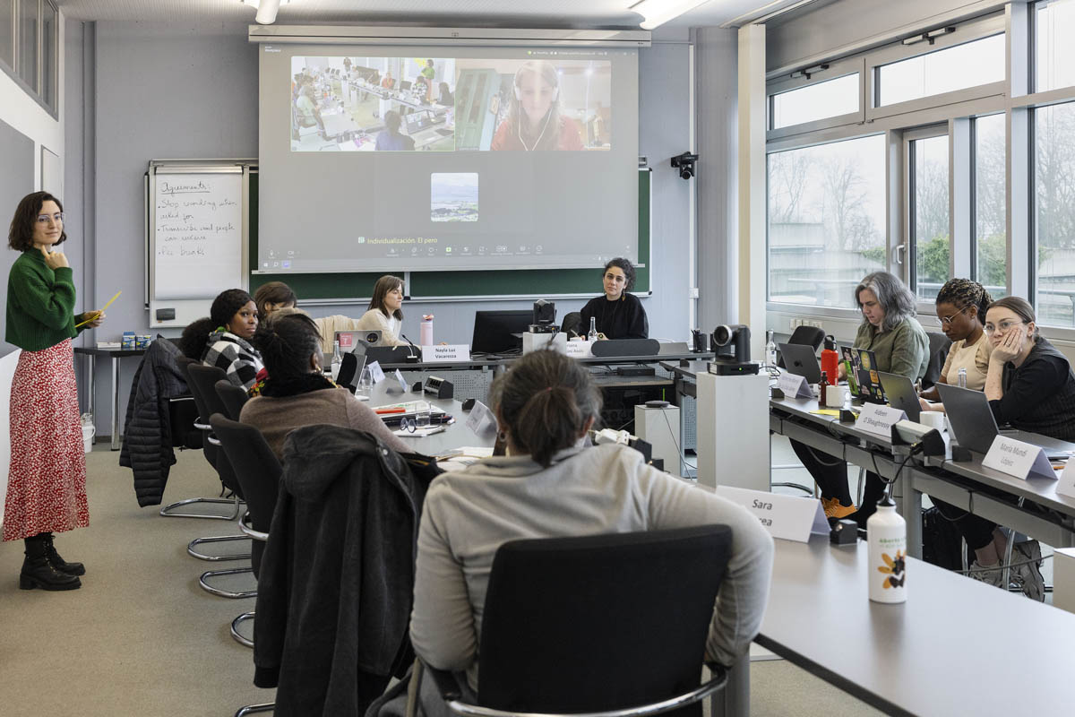 People sitting in the Long Table Room, discussing