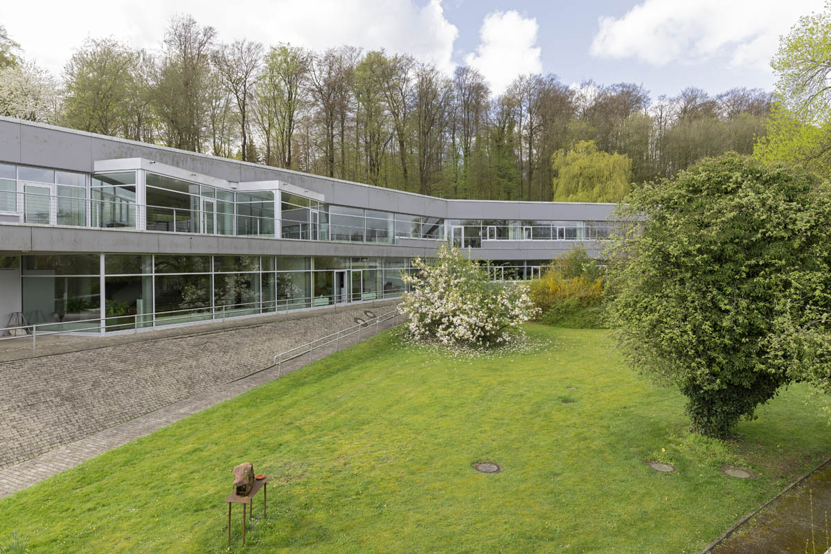 ZiF main building from the side, spring, flowers on the tree surrounding the building