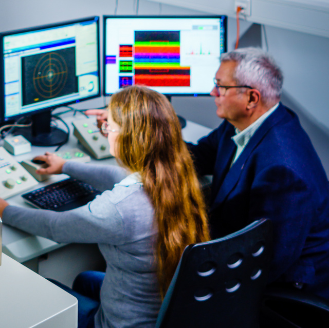 two people are working at a transmission electron microscope